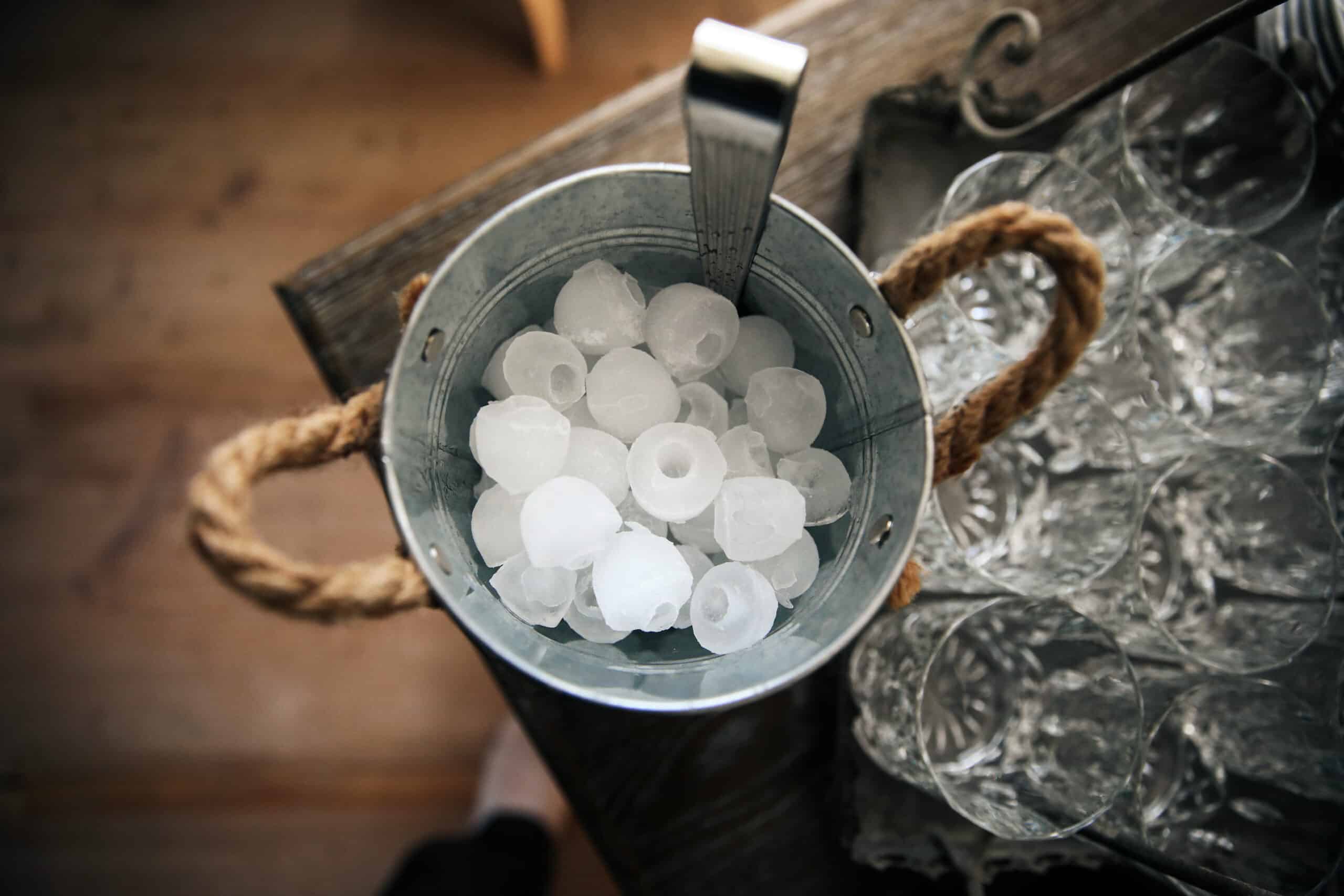 Bucket of ice cubes on a table, illustrating an ice maker not working diagnosis
