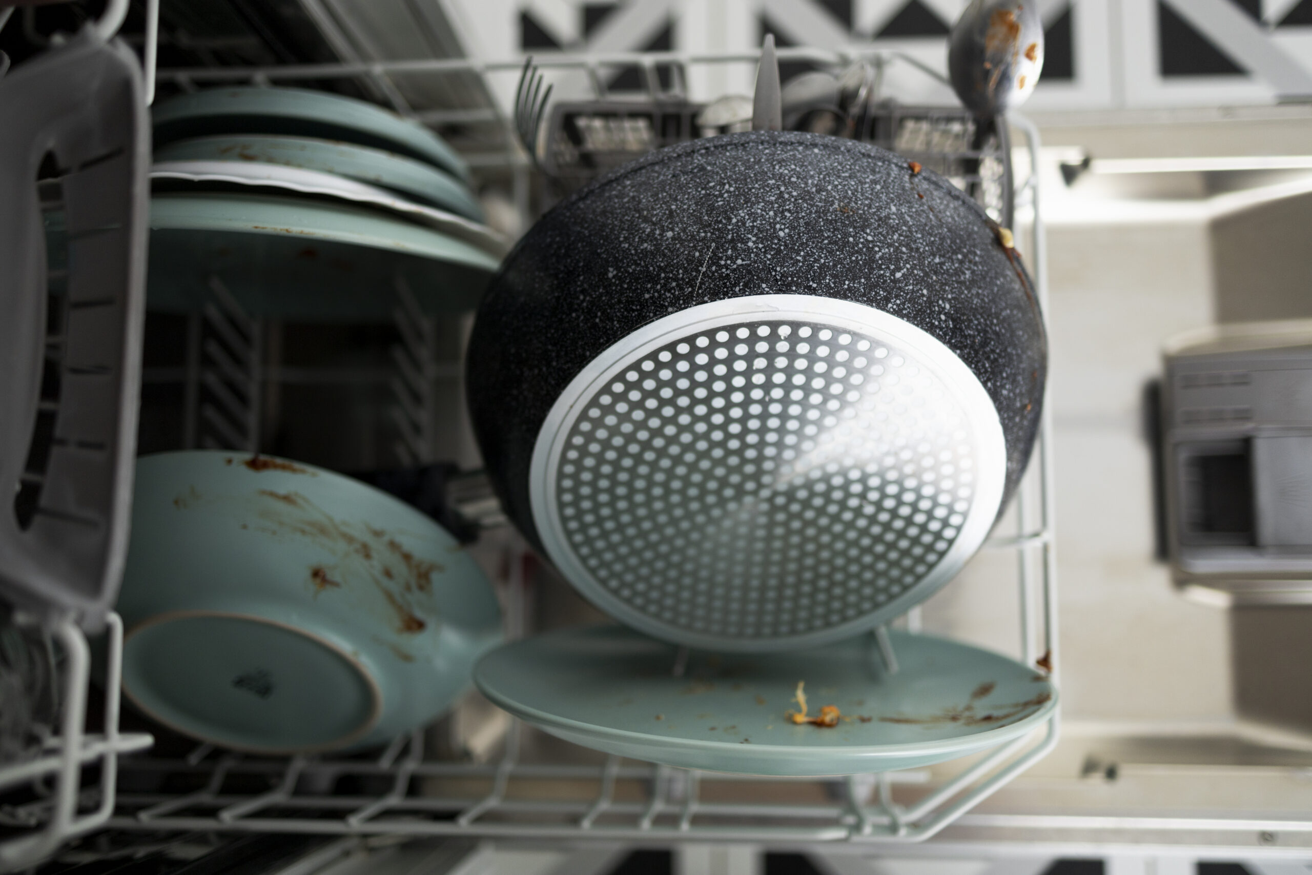 Dirty dishes sitting in a dishwasher, a common cause of bad odors