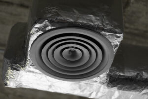 Close-up of a dryer vent duct, illustrating vent cleaning and fire safety