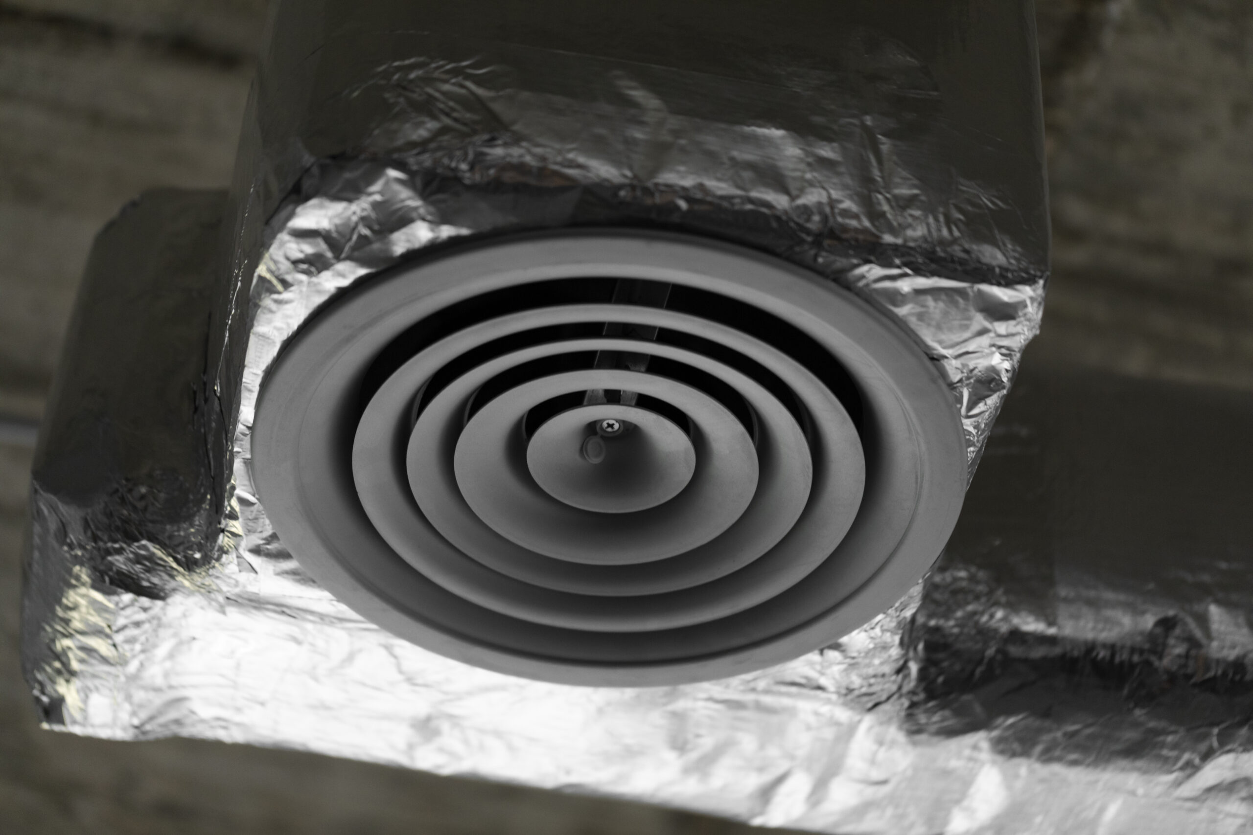 Close-up of a dryer vent duct, illustrating vent cleaning and fire safety