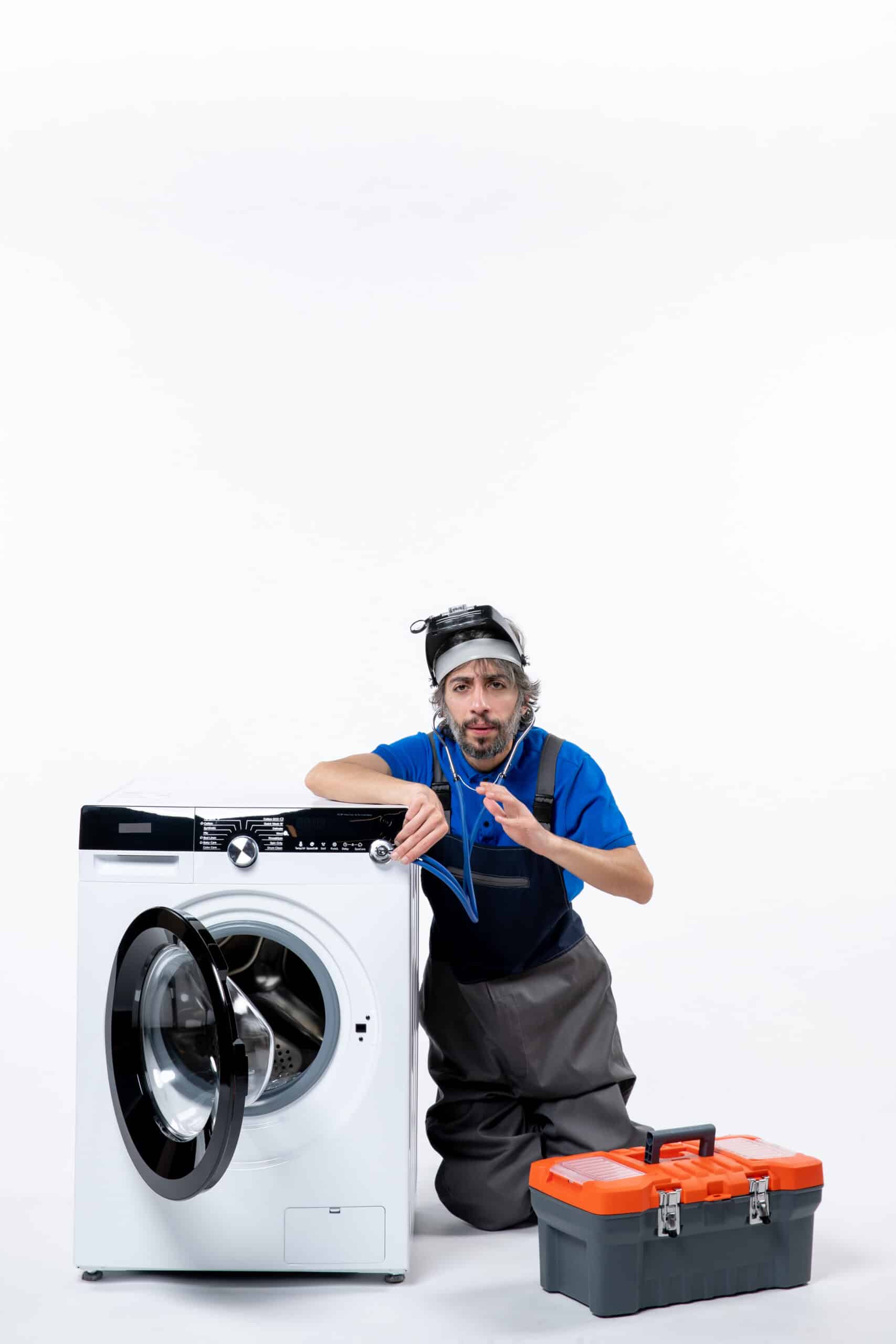 Repairman sitting near a washing machine using a stethoscope, illustrating Bosch washer error code E18 drain timeout