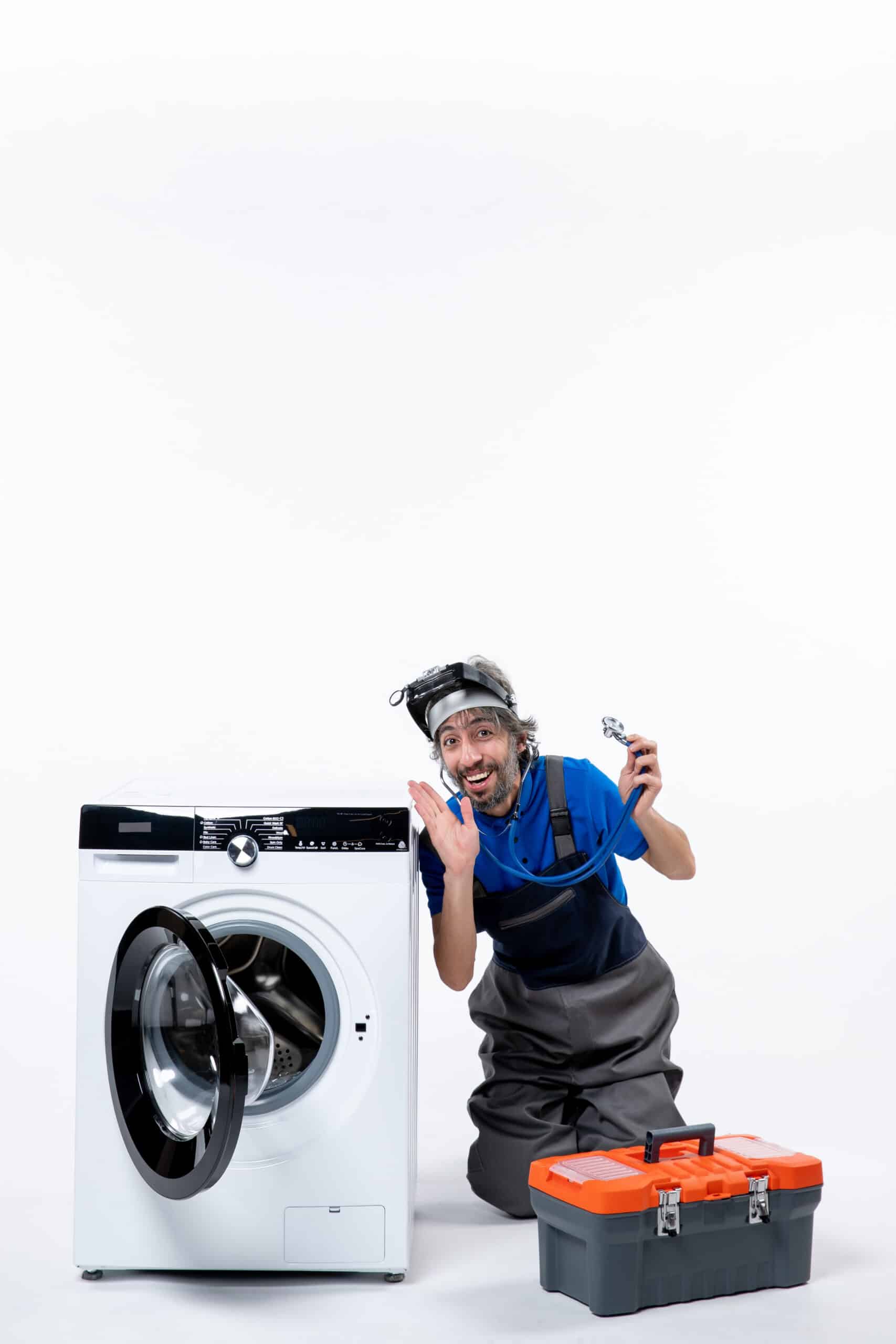 Repairman holding a stethoscope sitting near a washing machine, illustrating Whirlpool washer F06 error code motor speed sensor fault