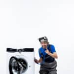 Repairman putting a stethoscope on a washing machine while sitting nearby, illustrating Whirlpool washer F08 error code water heating fault
