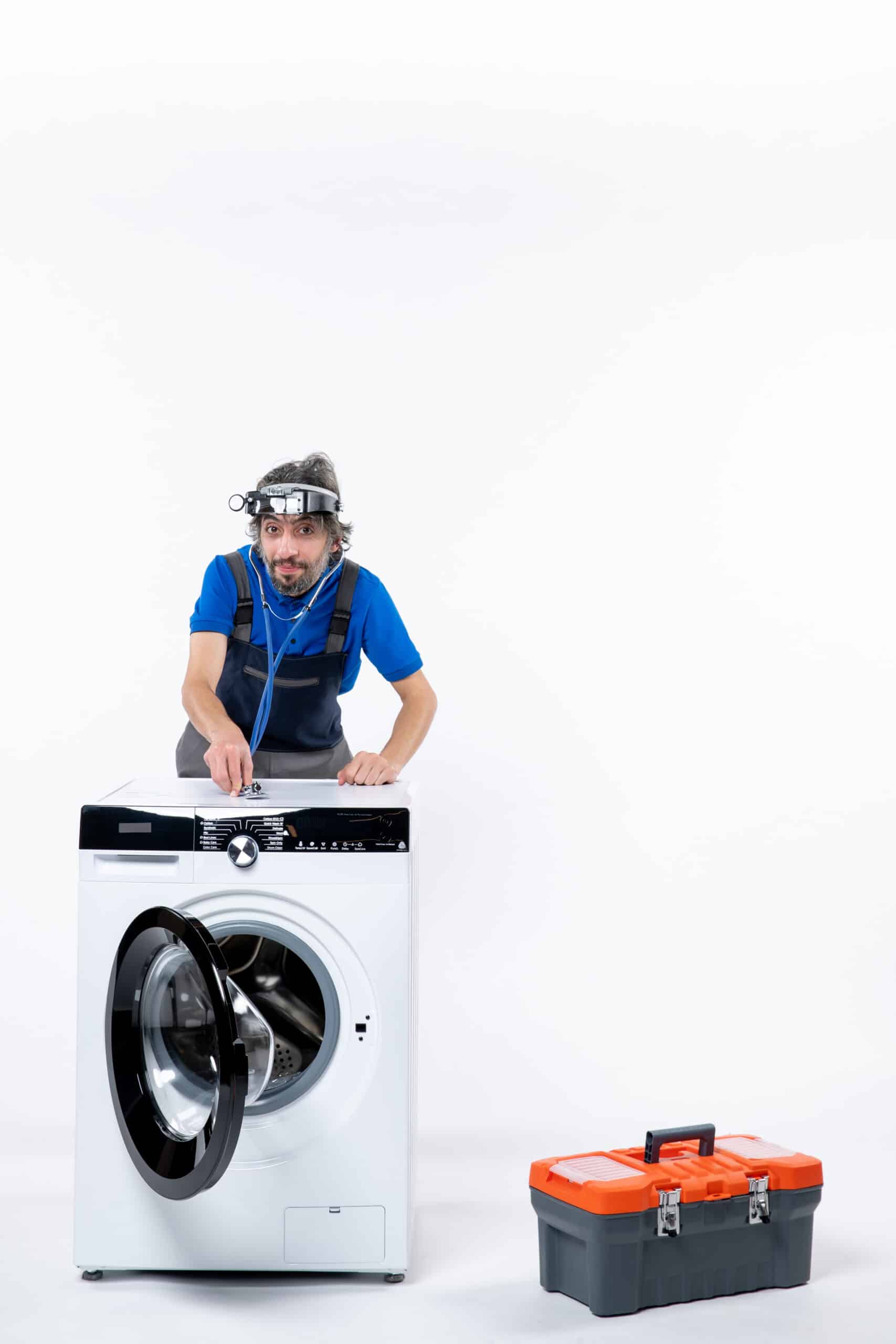 Repairman with a head lamp using a stethoscope on a washing machine, illustrating Whirlpool washer error code F22 motor communication error