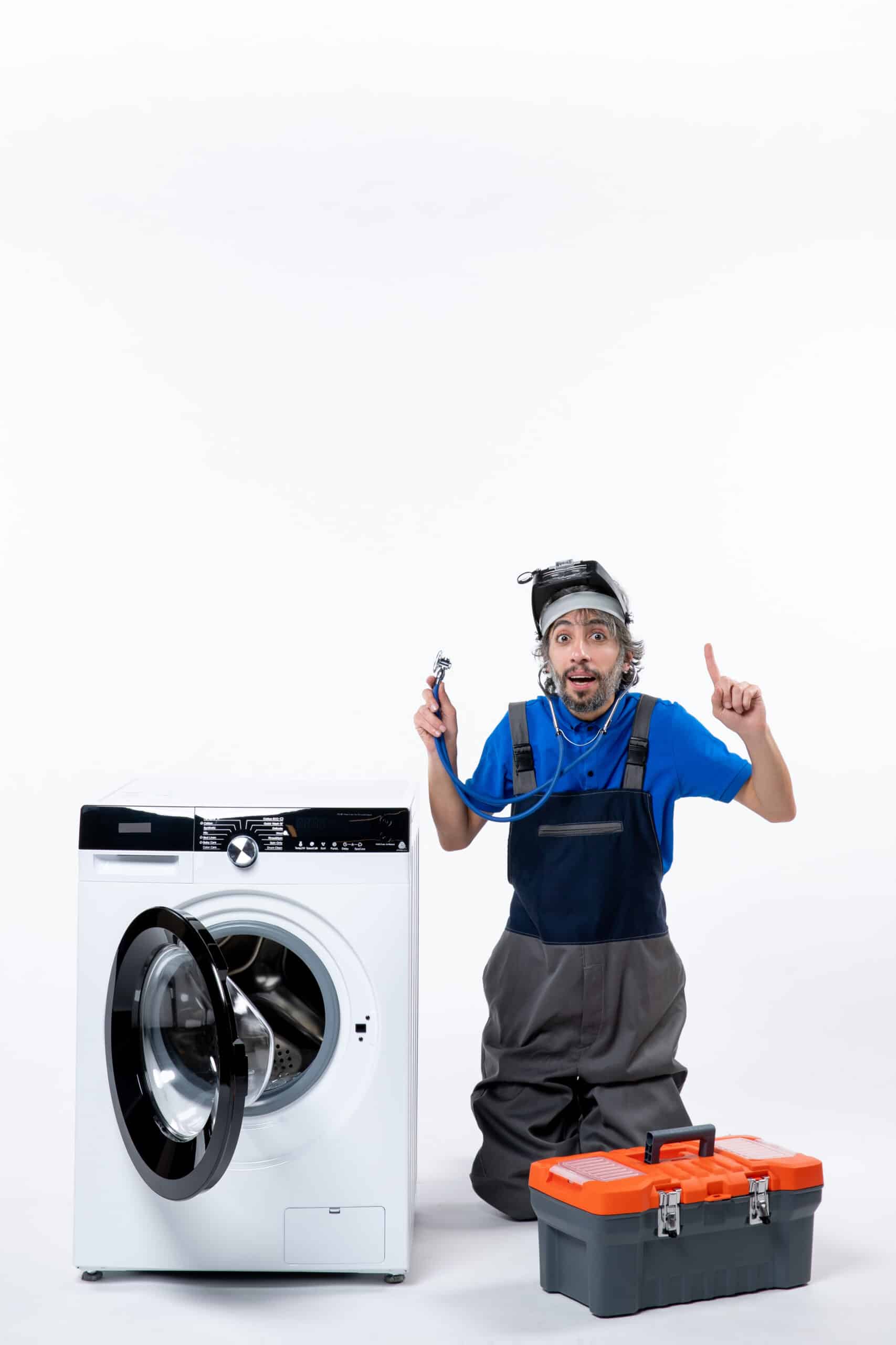 Repairman holding a stethoscope sitting near a washing machine, illustrating Whirlpool washer F15 error code drum position sensor fault