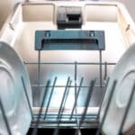 Close-up of clean plates inside a dishwasher rack, illustrating Frigidaire dishwasher error code PF loss of power