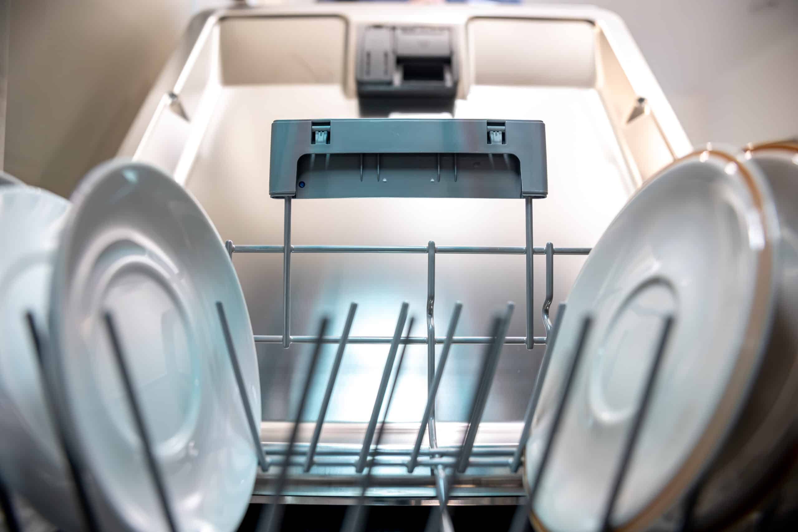 Close-up of clean plates inside a dishwasher rack, illustrating Frigidaire dishwasher error code PF loss of power