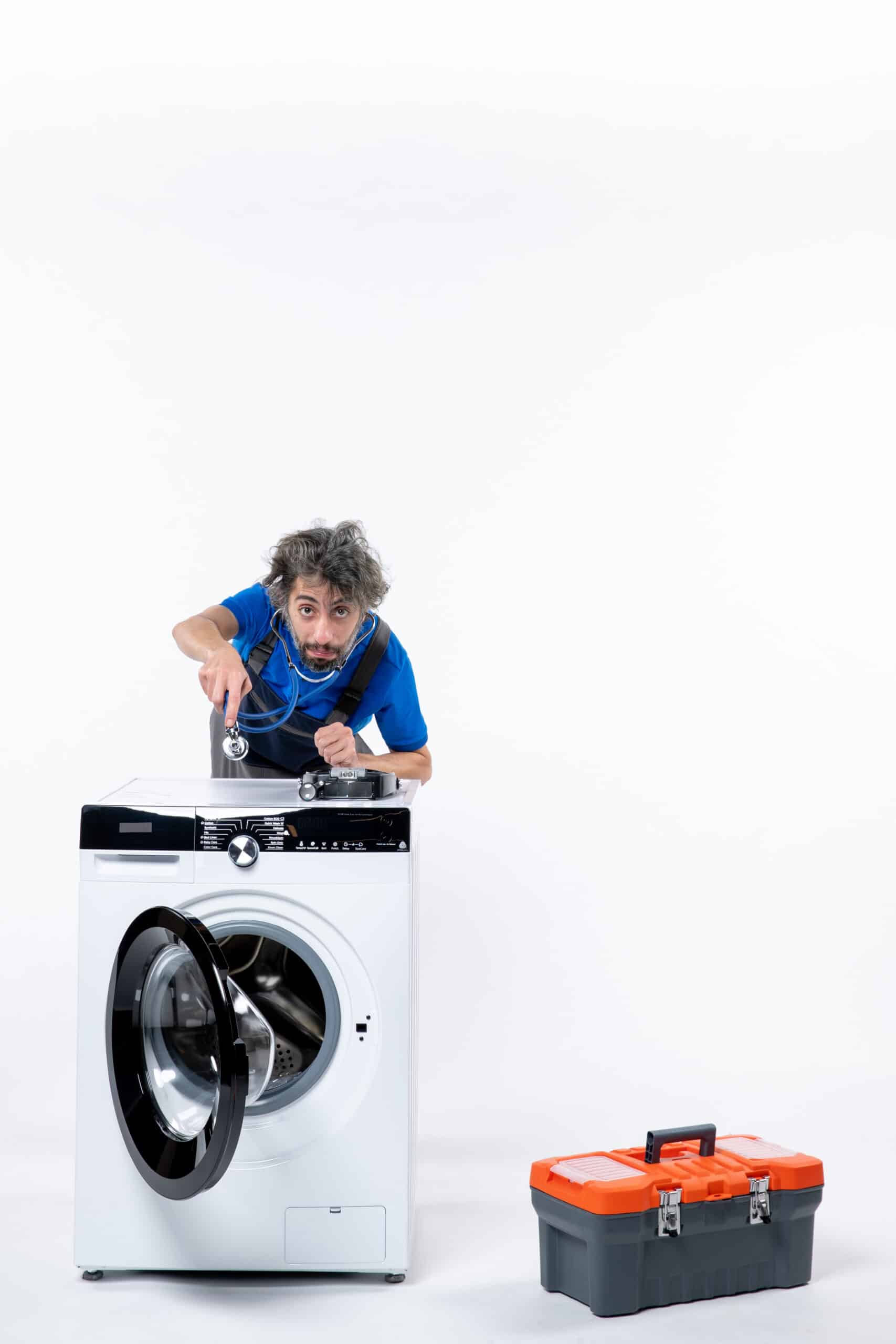 Repairman putting a stethoscope on a washing machine, illustrating LG washer error code IE water inlet error