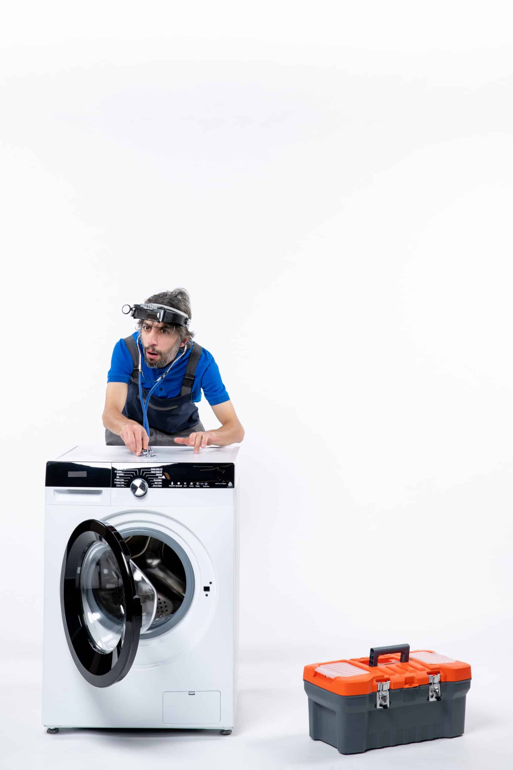 Repairman with a head lamp using a stethoscope on a washing machine, illustrating Whirlpool washer error code F7 E1 motor speed error