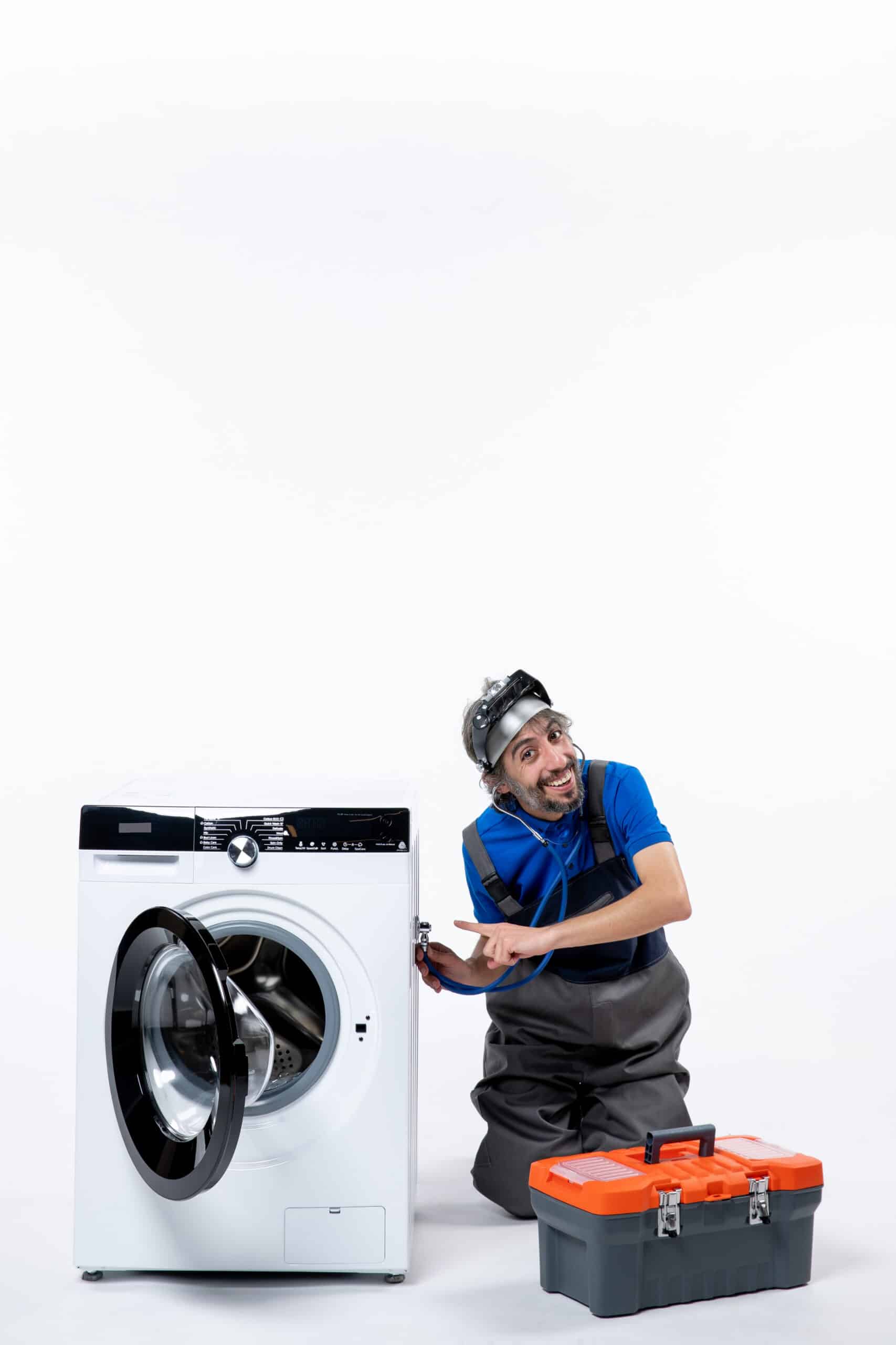 Young repairman putting a stethoscope on a washing machine with tools bag nearby, illustrating Whirlpool washer error code F06 motor speed sensor