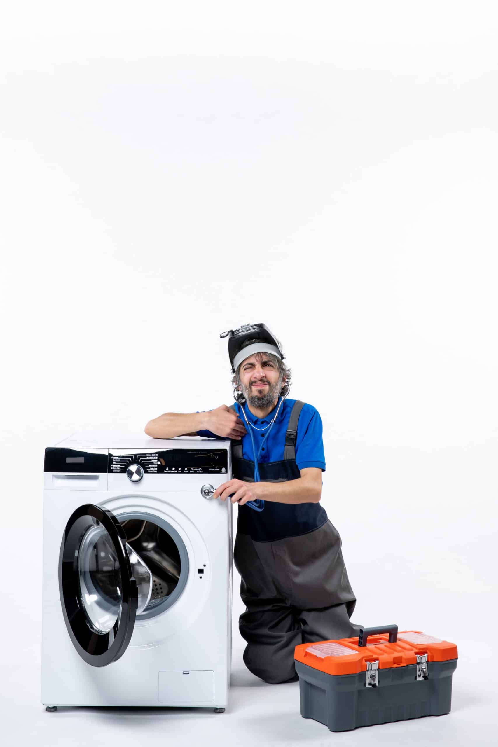 Repairman sitting near a washing machine, illustrating Whirlpool washer F22 error code motor communication fault