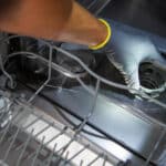Cleaning a dishwasher's filter as part of routine maintenance