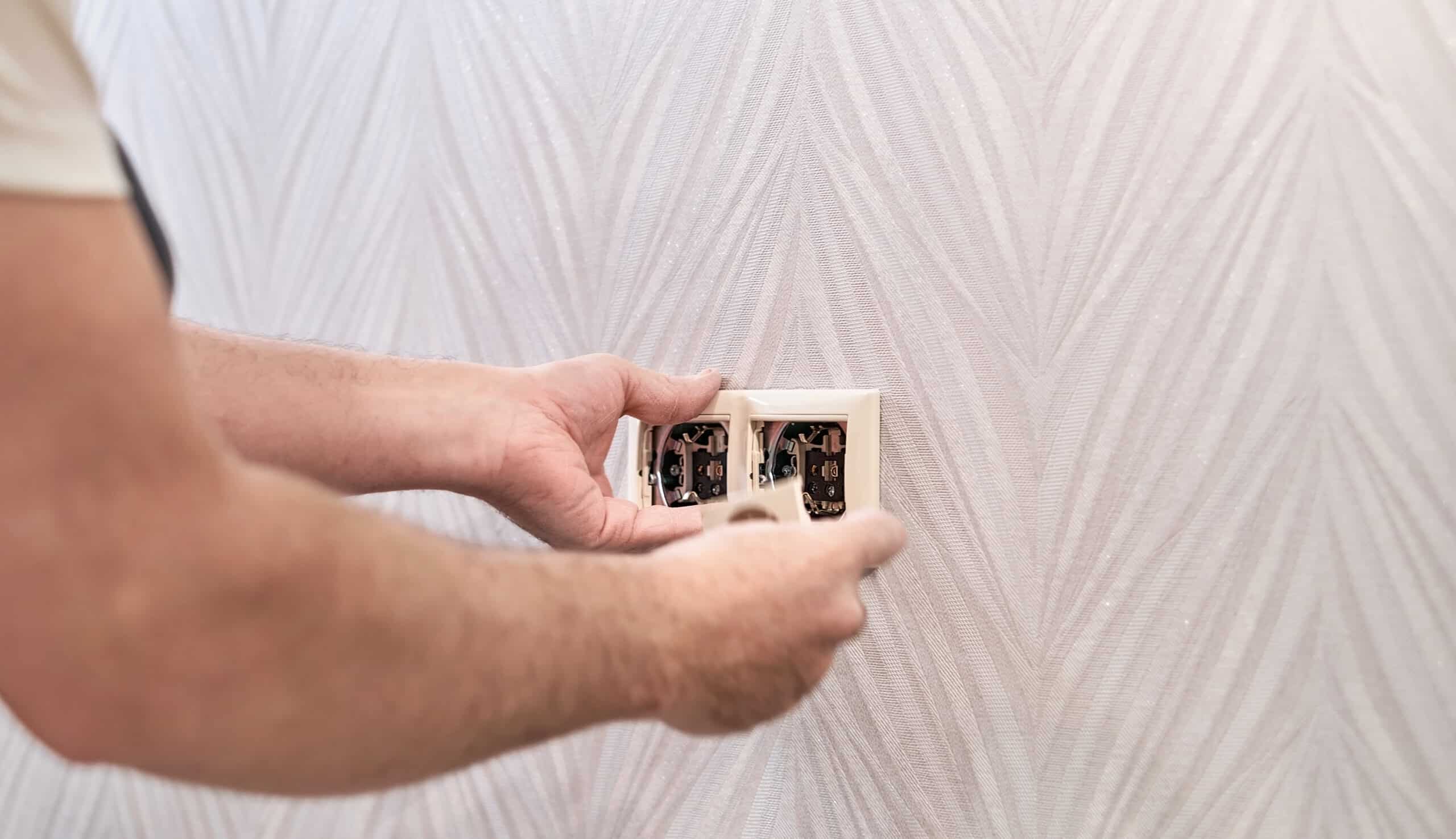 Electrician repairing a power outlet, illustrating Whirlpool dryer error code PF power failure memory