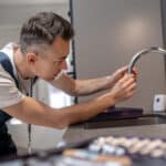 Technician checking a water supply valve related to a GE dishwasher H2O no-water-detected error