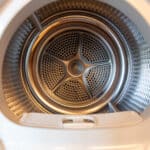 Close-up of a dryer drum perforation, illustrating Maytag dryer error code AF airflow fault