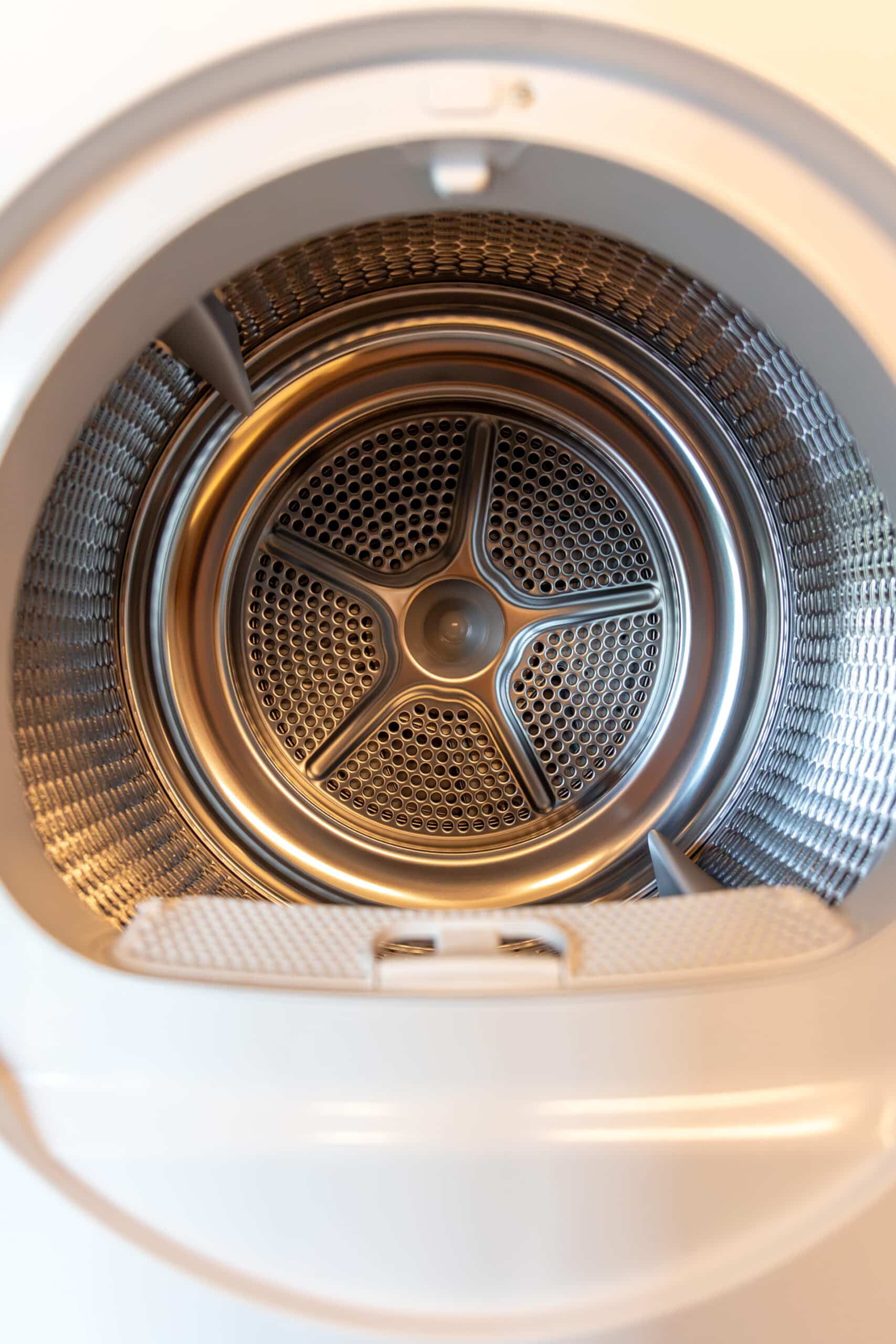 Close-up of a dryer drum perforation, illustrating Maytag dryer error code AF airflow fault