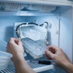 Inspecting a Samsung refrigerator ice maker during a repair diagnostic